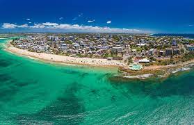 Academic Jobs Sunshine Coast skyline with pristine beaches and lush greenery