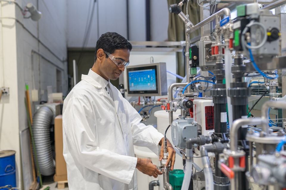 An image showcasing a biomedical engineer working on a cutting-edge medical device or conducting research in a lab, highlighting the integration of engineering and life sciences