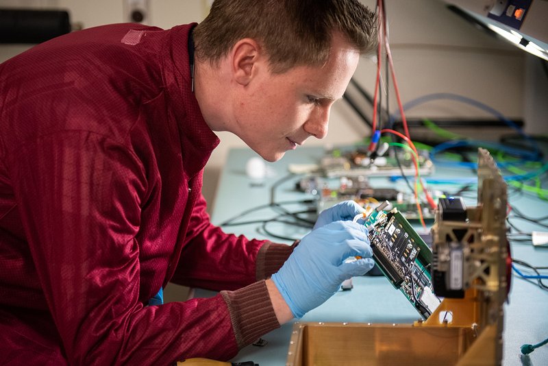 An image capturing the essence of Electronics, showcasing an engineer working on an intricate electronic device, symbolizing the meticulous and innovative nature of the field